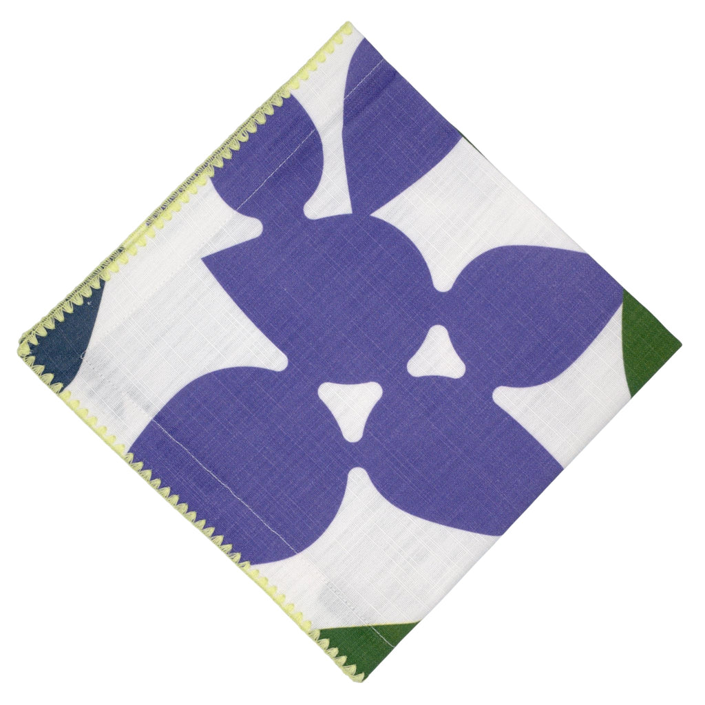 Hem And Tassel Celebration slub cotton dinner napkin with purple and green leaf confetti pattern and yellow trim