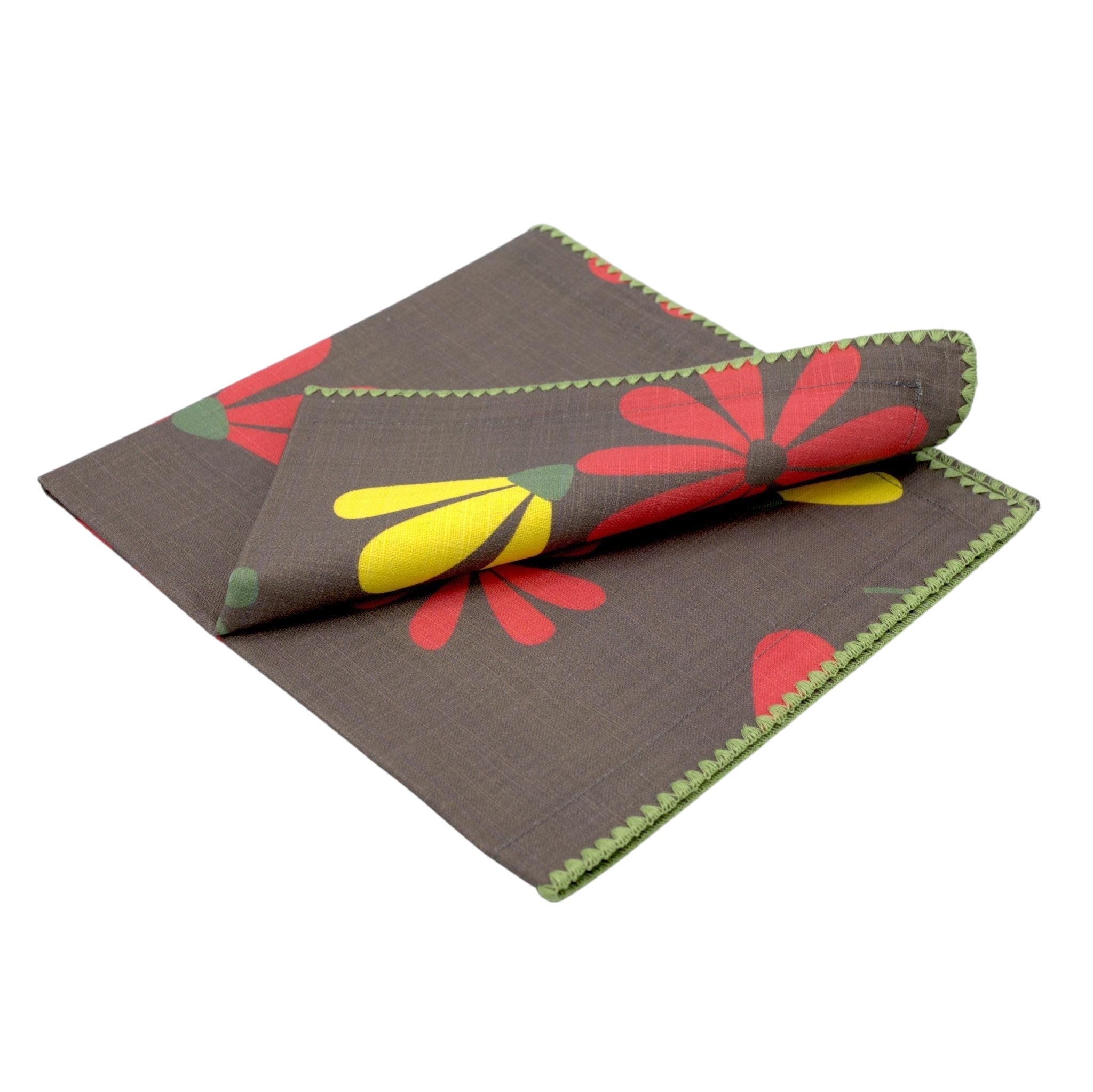 Hem And Tassel dinner napkin in brown double-slub cotton with a floral dragonfly pattern and green stitched edges.