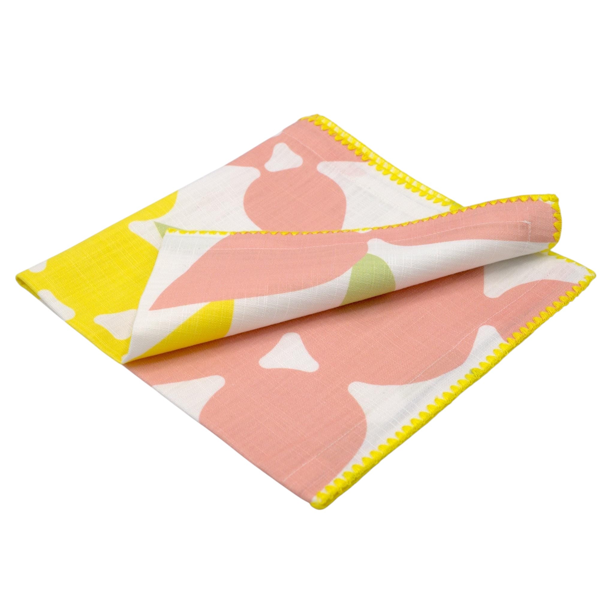 Hem And Tassel Celebration slub cotton dinner napkin with pink and yellow confetti pattern and yellow stitched edge