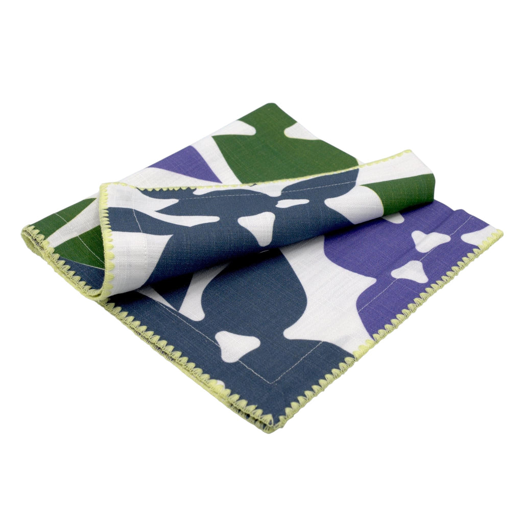 Hem And Tassel Celebration slub cotton dinner napkin with green, purple, and white leaf-inspired confetti pattern