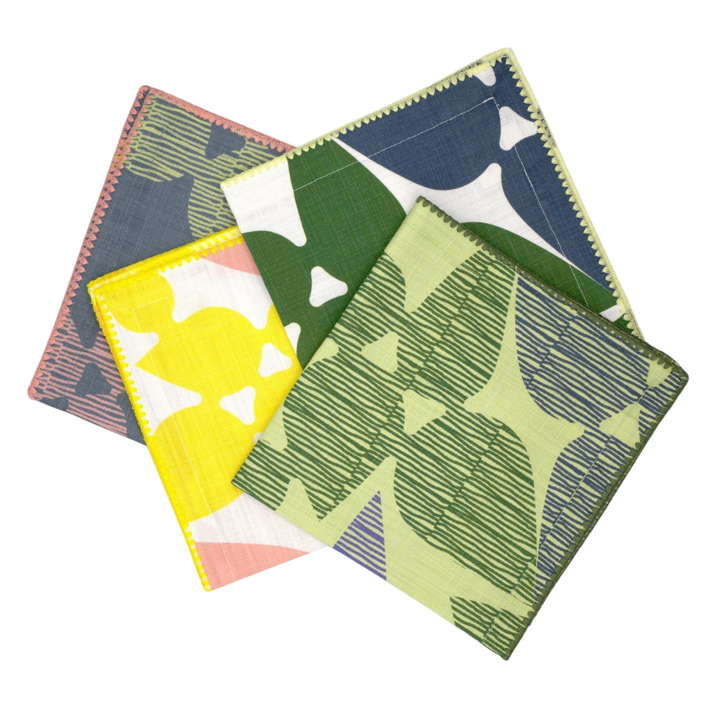 Hem And Tassel Celebration slub cotton dinner napkins featuring colorful confetti and leaf-inspired patterns.