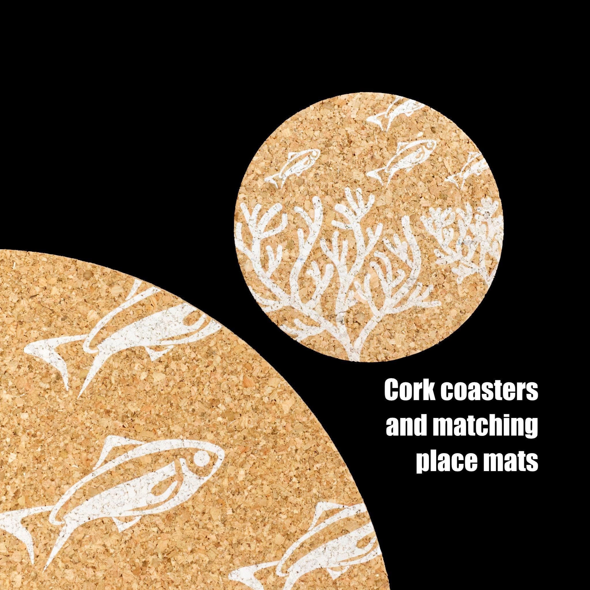 Cork coaster and placemat with fish and coral design on a black background from Hem And Tassel 