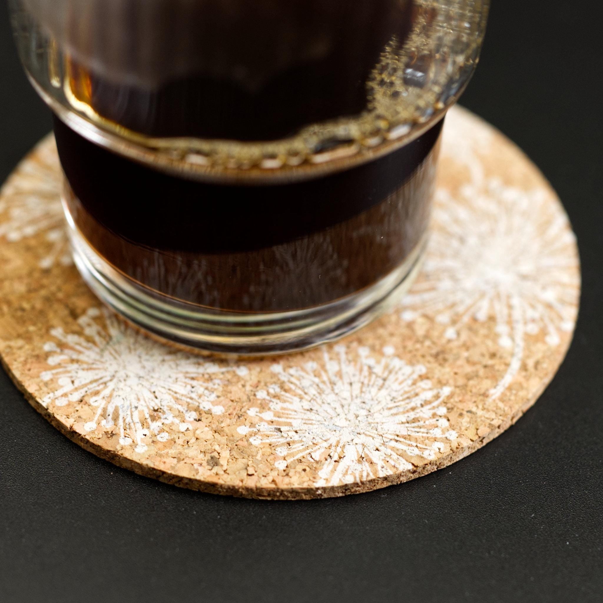 home by the sea cork coaster from Hem And Tassel with coffee glass on black background