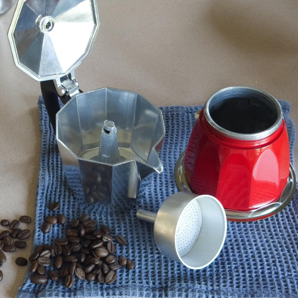 induction moka pot coffee maker opened up, and coffee beans on a blue cloth from Hem And Tassel 