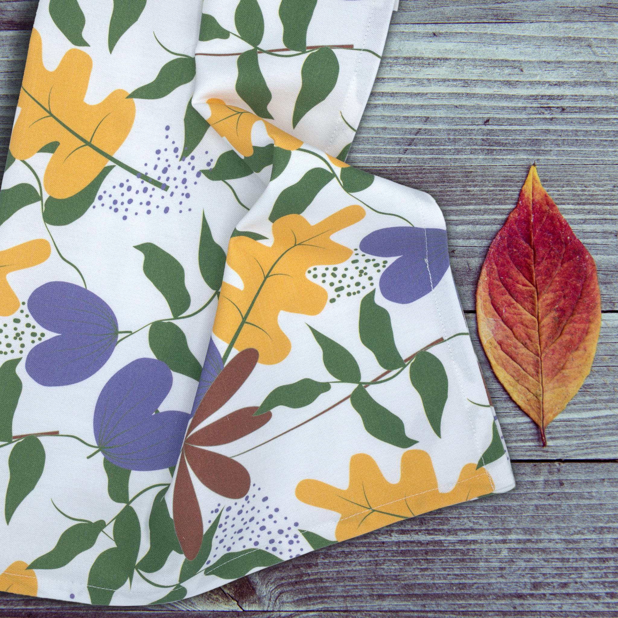 just leaves tea towel mussed up with colorful leaf pattern on a wooden surface from Hem And Tassel 