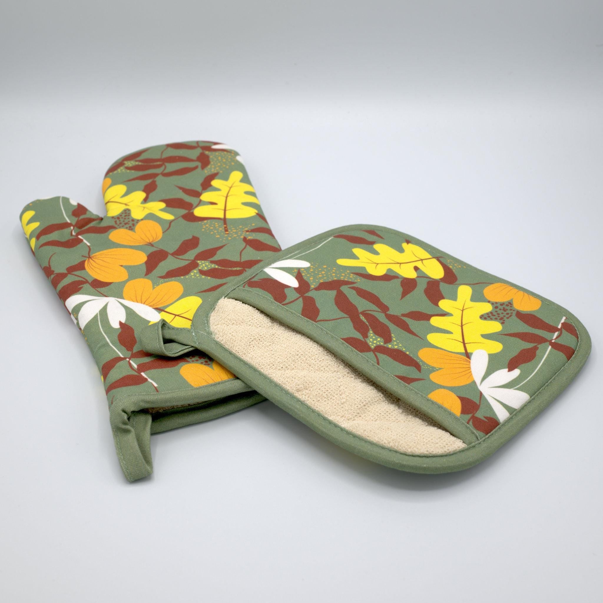 Pair of oven mitt and pot holder with leaf pattern on a gray background from Hem And Tassel 