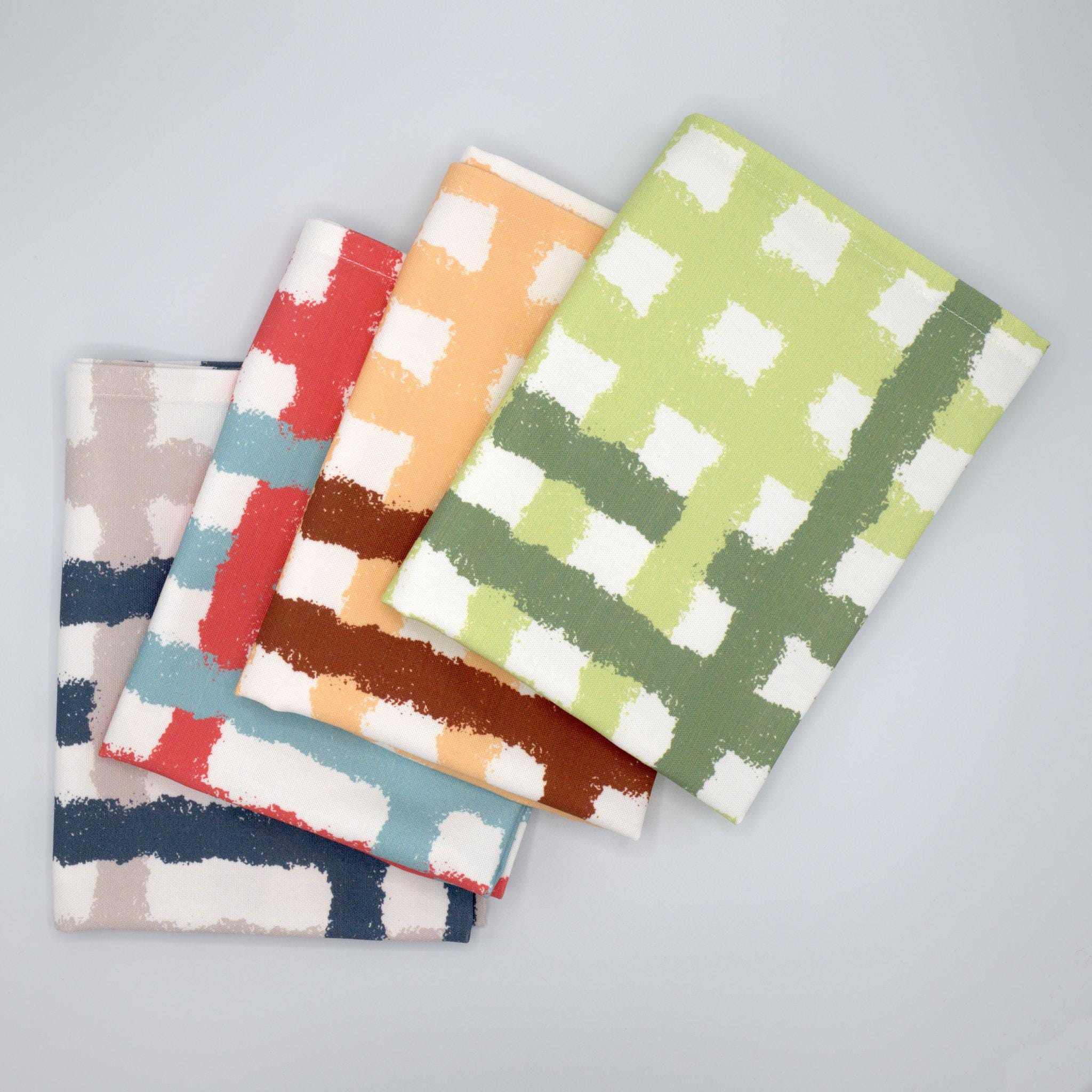 fanned cotton tea towels in all color choices of jute impossible pattern from Hem And Tassel on a gray background