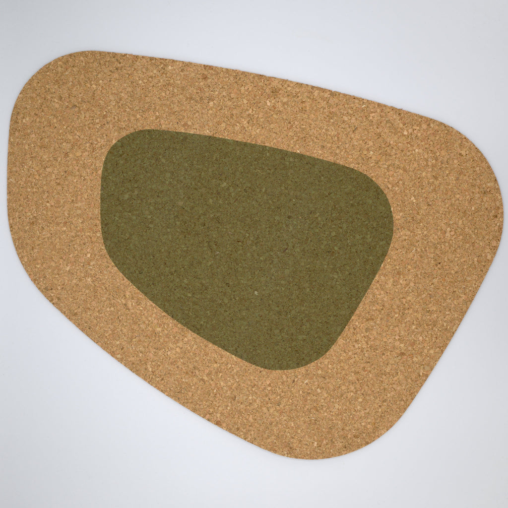 a kidney bean shaped large cork placemat with a green color block on a white background