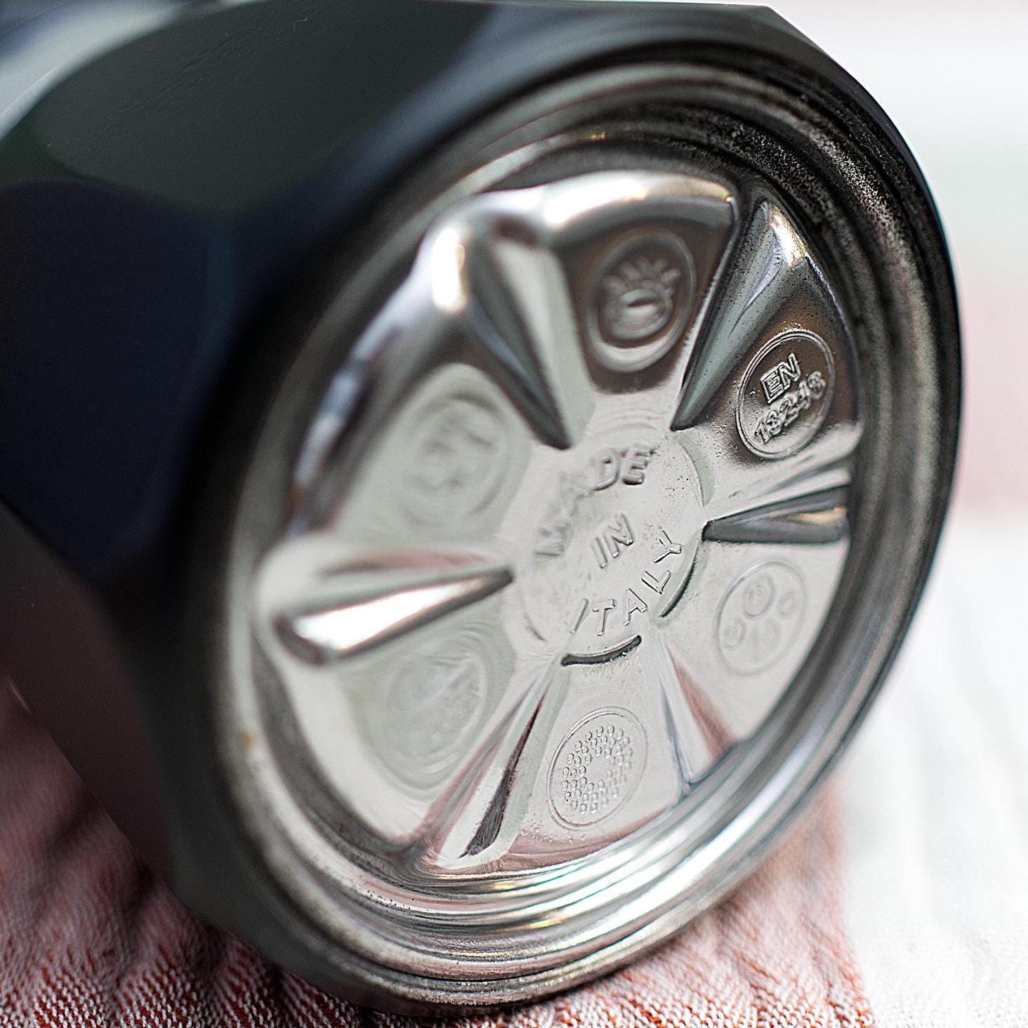 Close-up of bottom of Italian Moka Pot with engraved Made in Italy text and logos