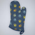 Colorful mushroom magic cotton oven mitt  from Hem And Tassel, on a wooden surface
