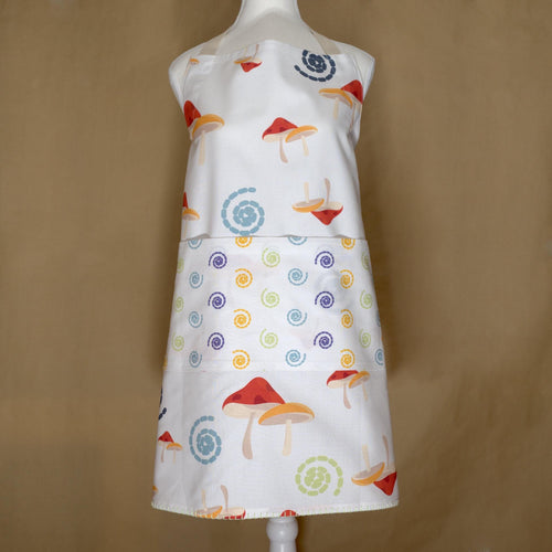 magic mushroom apron with mushroom and spiral pattern on a mannequin against a brown background from Hem And Tassel 