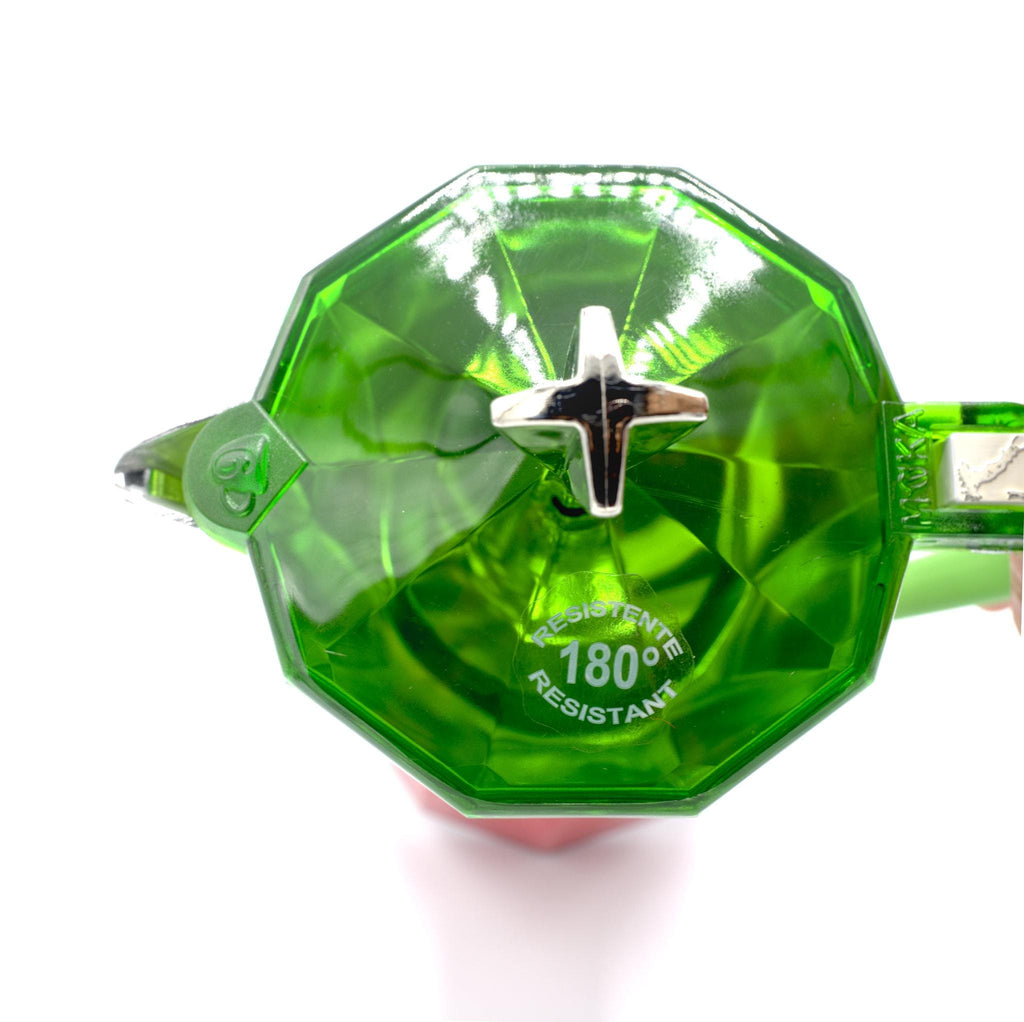 Green translucent lid with temperature resistance label of the moka pot on a white background