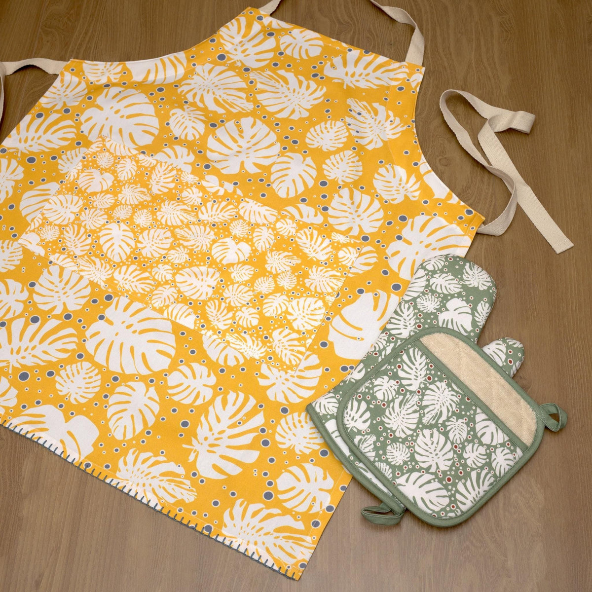 rich cotton oven mitt and pot holder in winter color, with orange apron in monster-ah design - from Hem And Tassel