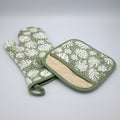 rich cotton oven mitt and pot holder in turf color of monster-ah design against a light grey backdrop - from Hem And Tassel