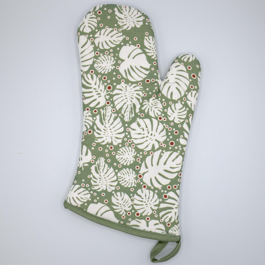 rich cotton oven mitt in turf color of monster-ah design against a light grey backdrop - from Hem And Tassel