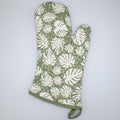 rich cotton oven mitt in turf color of monster-ah design against a light grey backdrop - from Hem And Tassel
