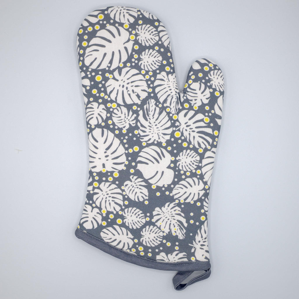 rich cotton oven mitt in winter color of monster-ah design against a light grey backdrop - from Hem And Tassel
