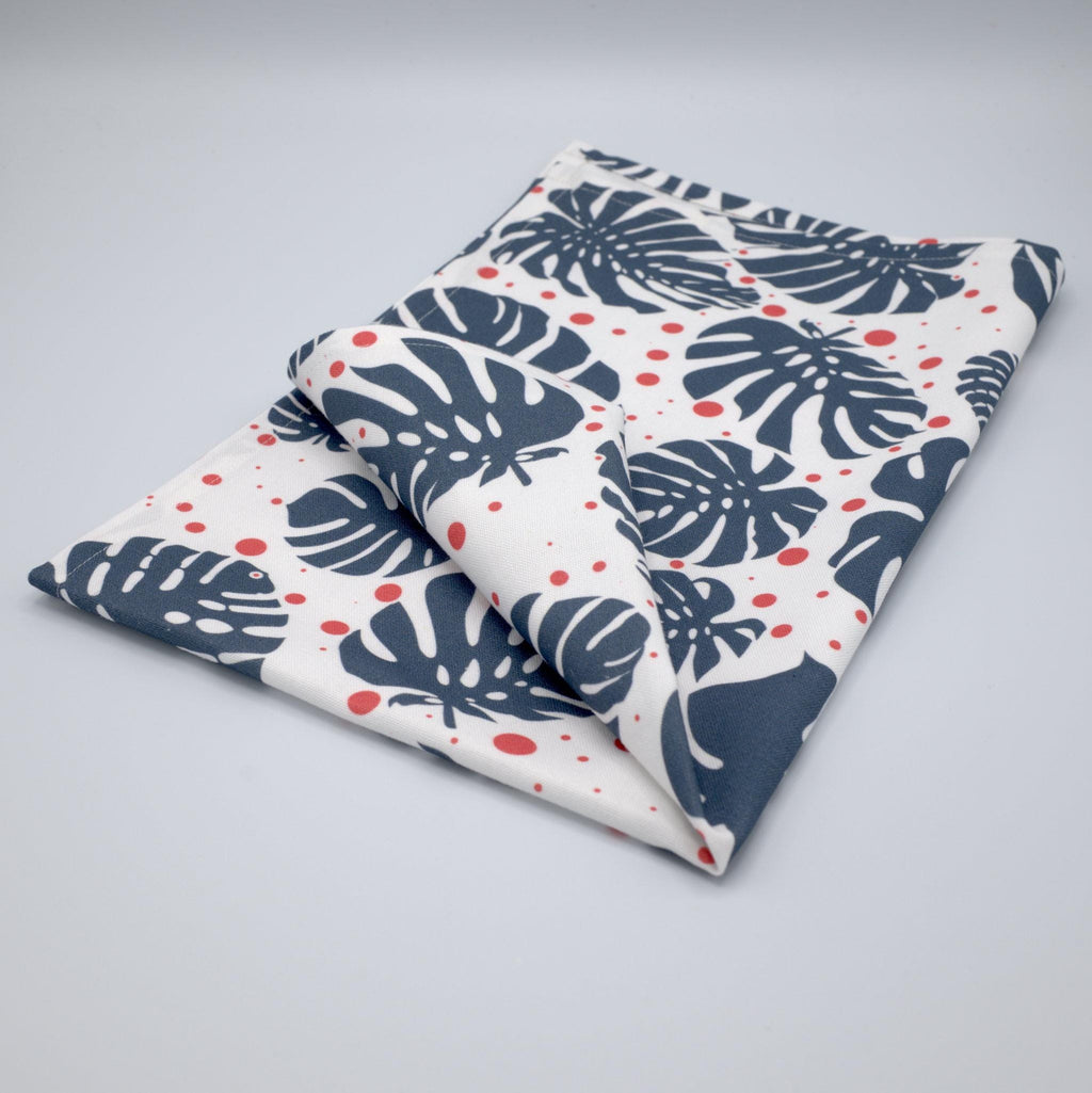 monster ah kitchen towel with leaf pattern folded  on a light gray background from Hem And Tassel 