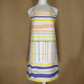 rich cotton percale apron in not-straight design in Spring colors on a mannequin - from Hem And Tassel