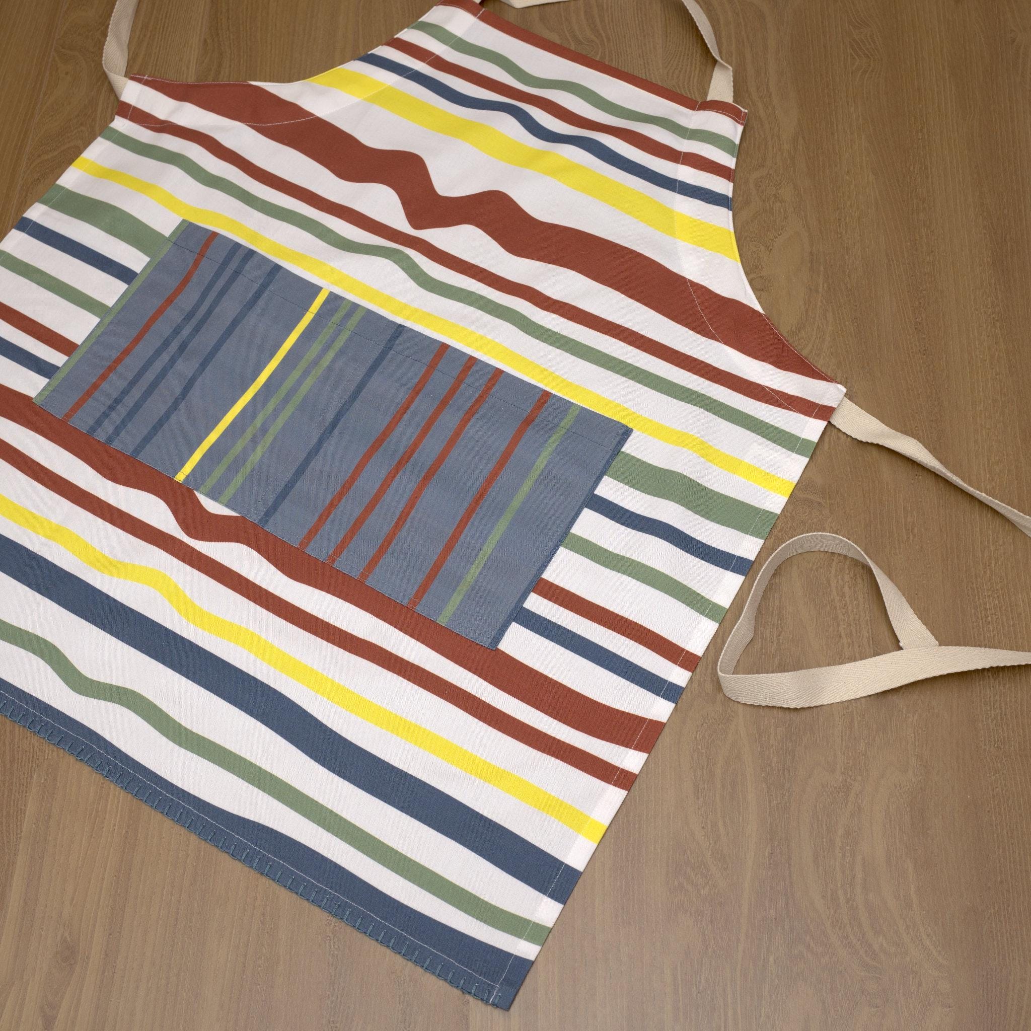 Colorful striped not straight clay apron  on a wooden surface from Hem And Tassel 