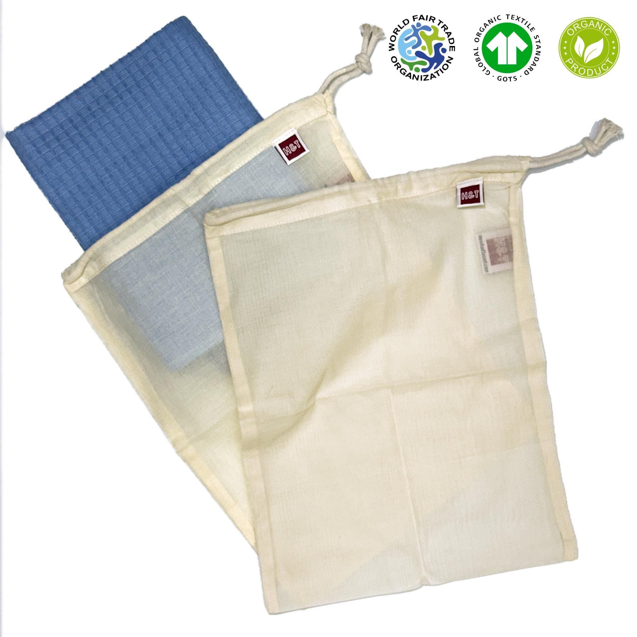 Two fine organic cotton mesh bags with a blue towel inside, featuring organic certification logos on a white background from Hem And Tassel 