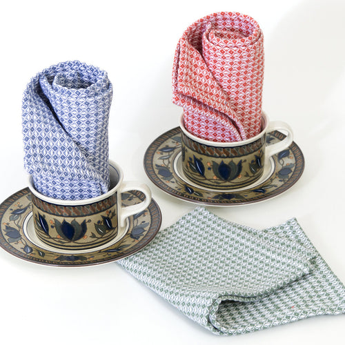 Three patterned diamond waffle wash cloths  in cups and saucers on a white background from Hem And Tassel 