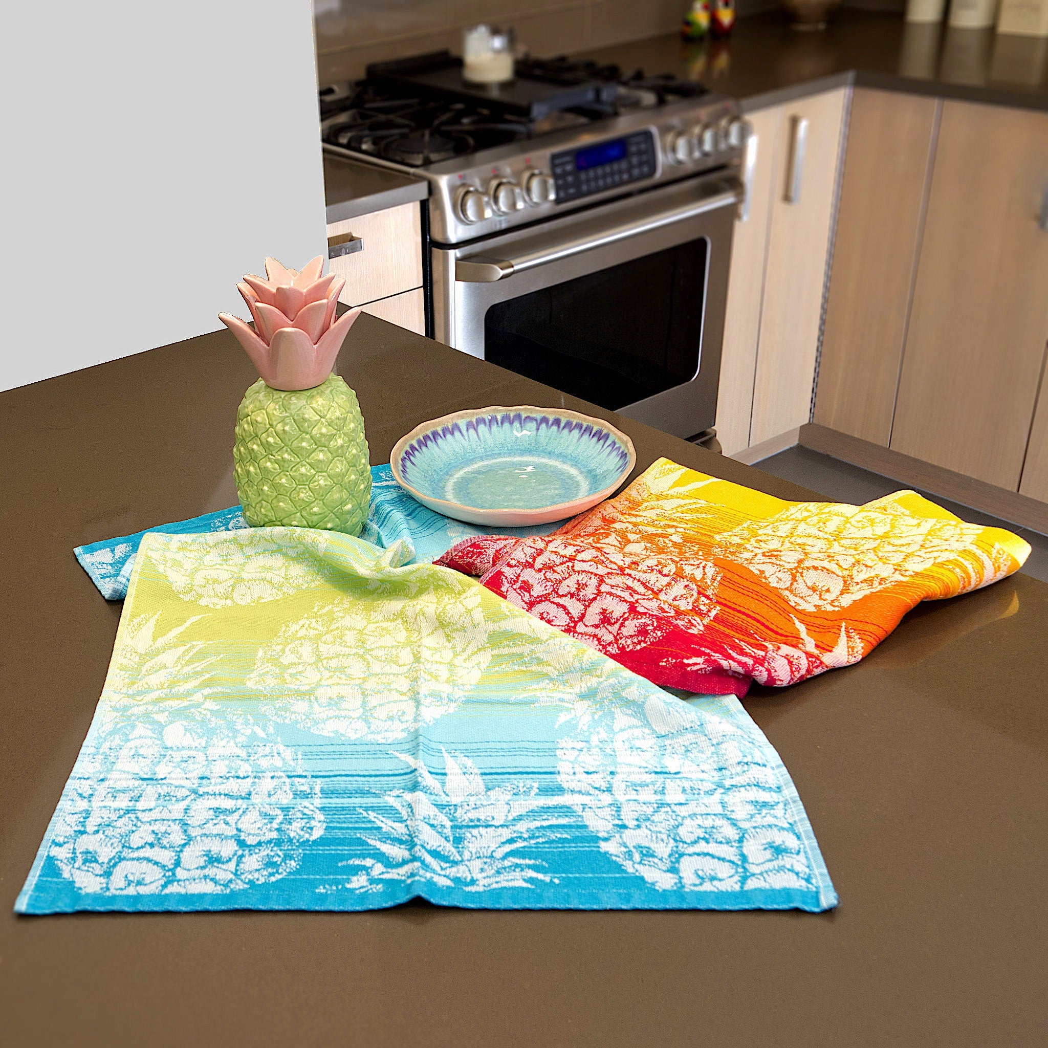 two cotton jacquard towels in pineapple design on kitchen counter with from Hem And Tassel with pineapple decor and plate