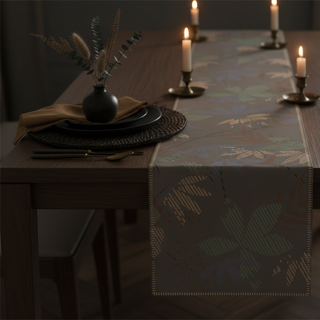A dark wood dining table styled with a patterned table runner, place settings, and lit candles in a dimly lit room from Hem And Tassel 