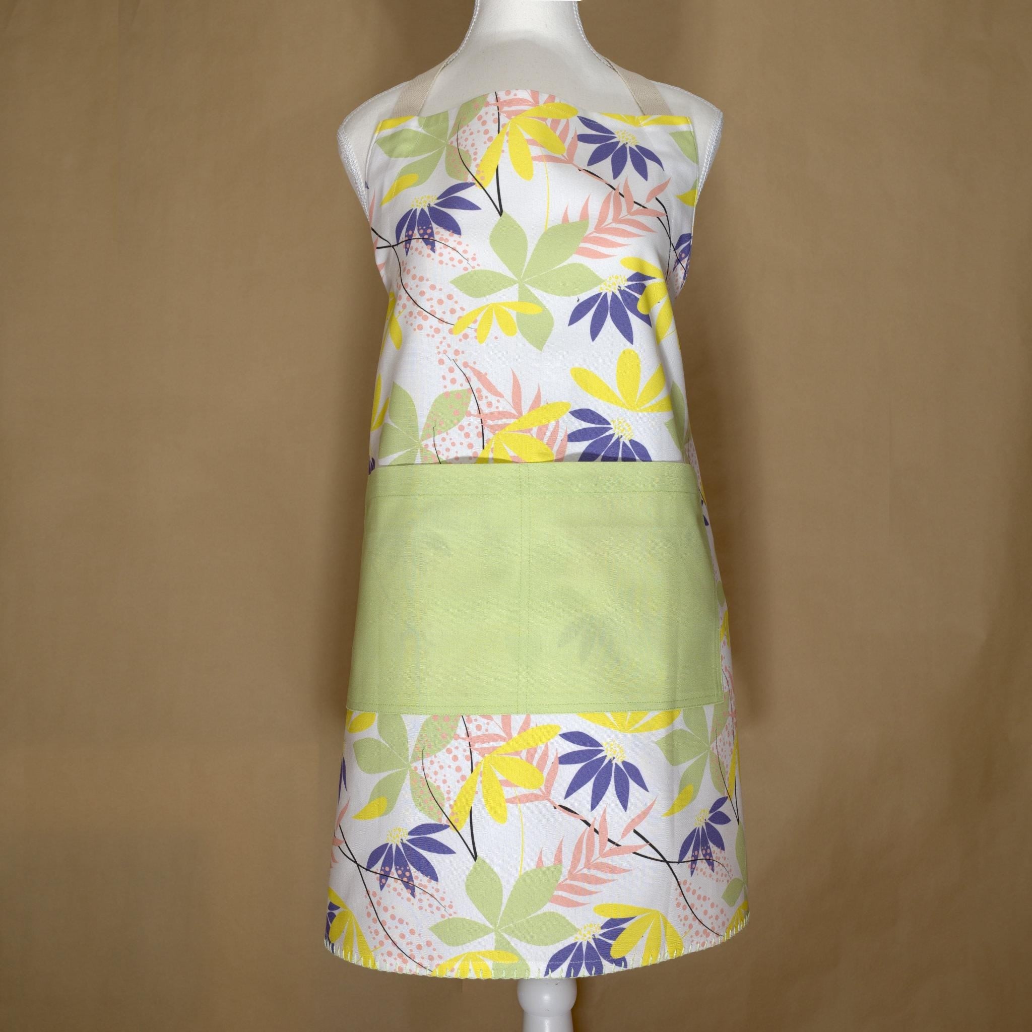 Floral pollen up apron on a mannequin against a brown background from Hem And Tassel 