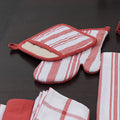 Decade classic cotton oven mitt and pot holder in red, on a dark wooden background - from Hem And Tassel