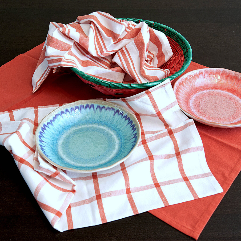 Ceramic plates with red decade classic set of 3 kitchen towels and basket in the background from hem and tassel