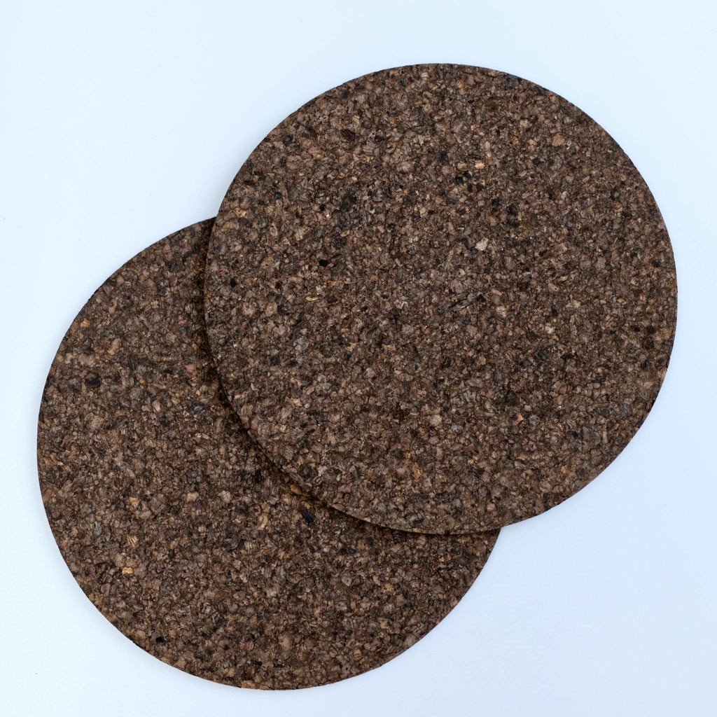 set of two matt black black cork placemat from Hem And Tassel on light grey background