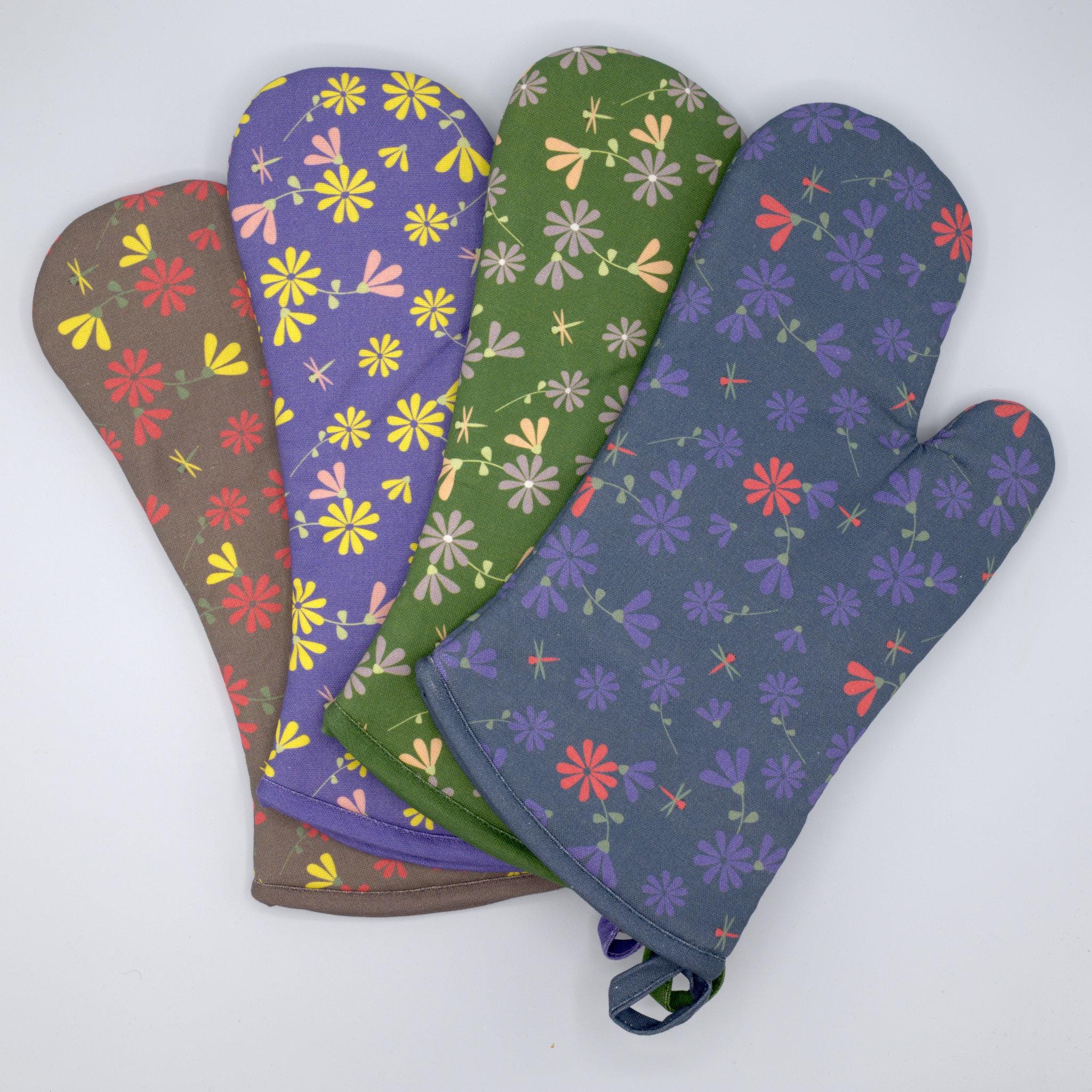 Set of four floral-patterned shy dragonfly oven mitts on a white background from Hem And Tassel 