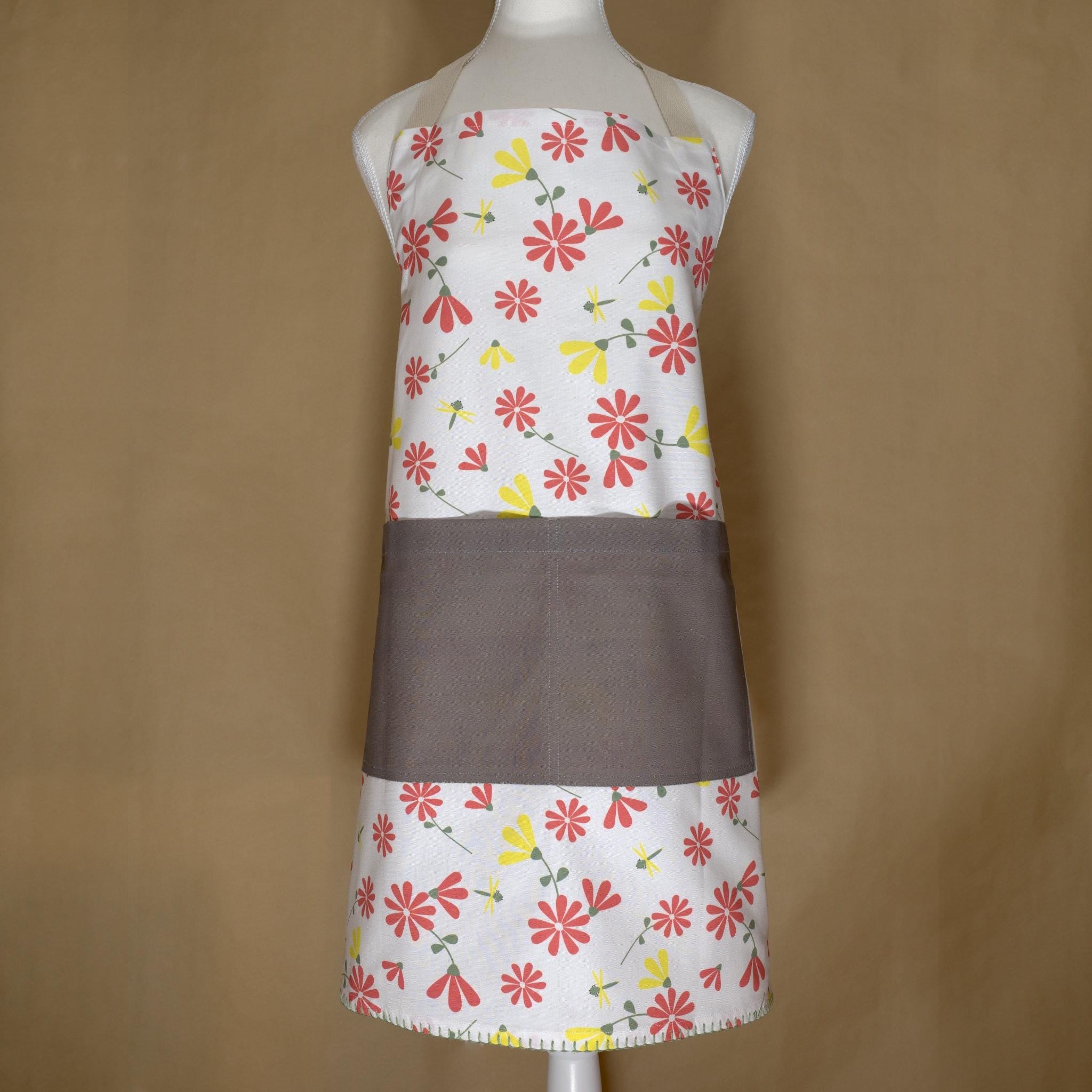 shy dragonfly apron in pink and yellow on a mannequin from Hem And Tassel 