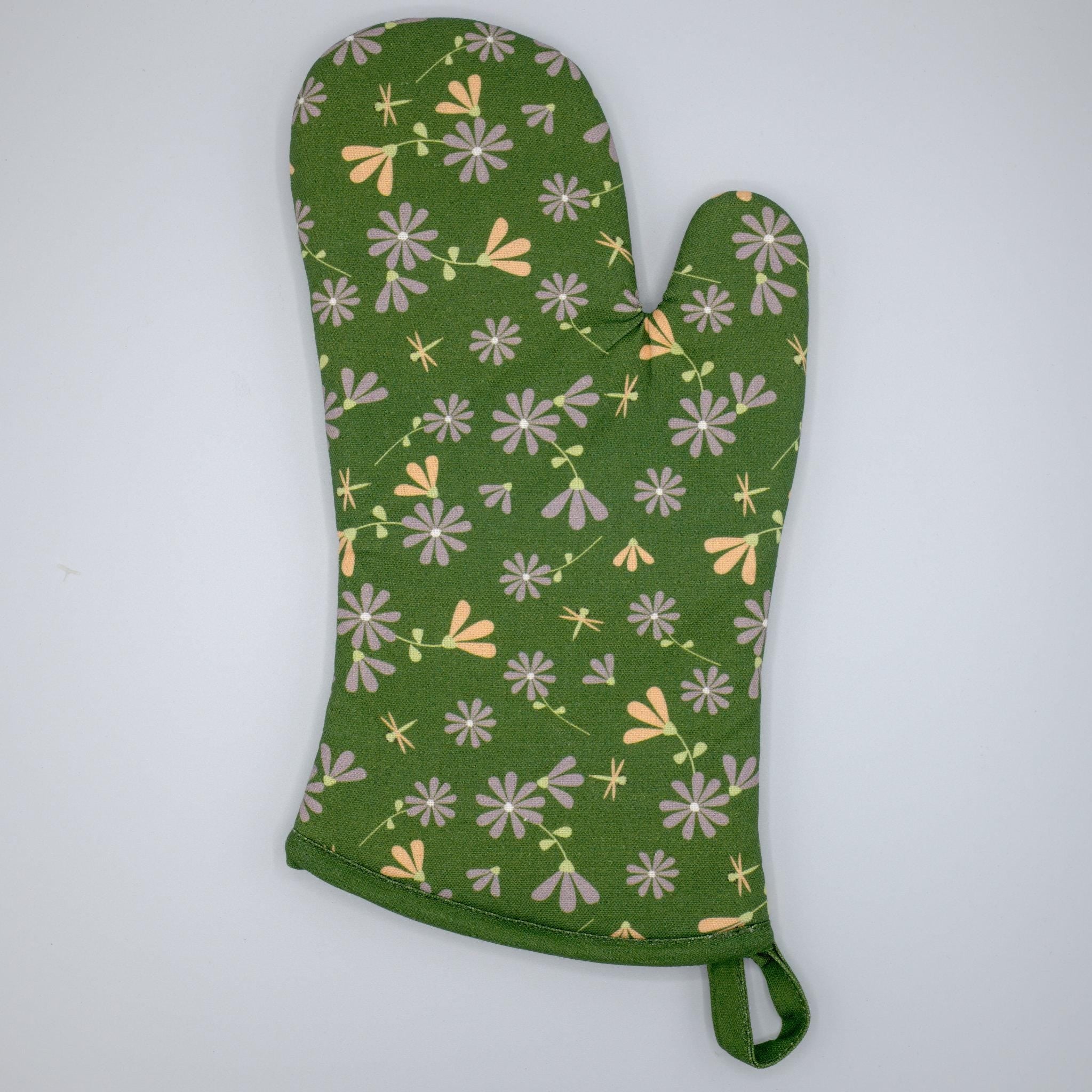 Green floral-patterned  shy dragonfly oven mitt on a white background from Hem And Tassel 