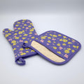 Purple shy dragonfly oven mitt and pot holder with floral pattern on a white background from Hem And Tassel 