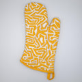 rich cotton oven mitt in orange color of squiggles design against light grey backdrop - from Hem And Tassel