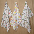 set of three colorful cotton percale tea towels of thingies design hanging on wood background