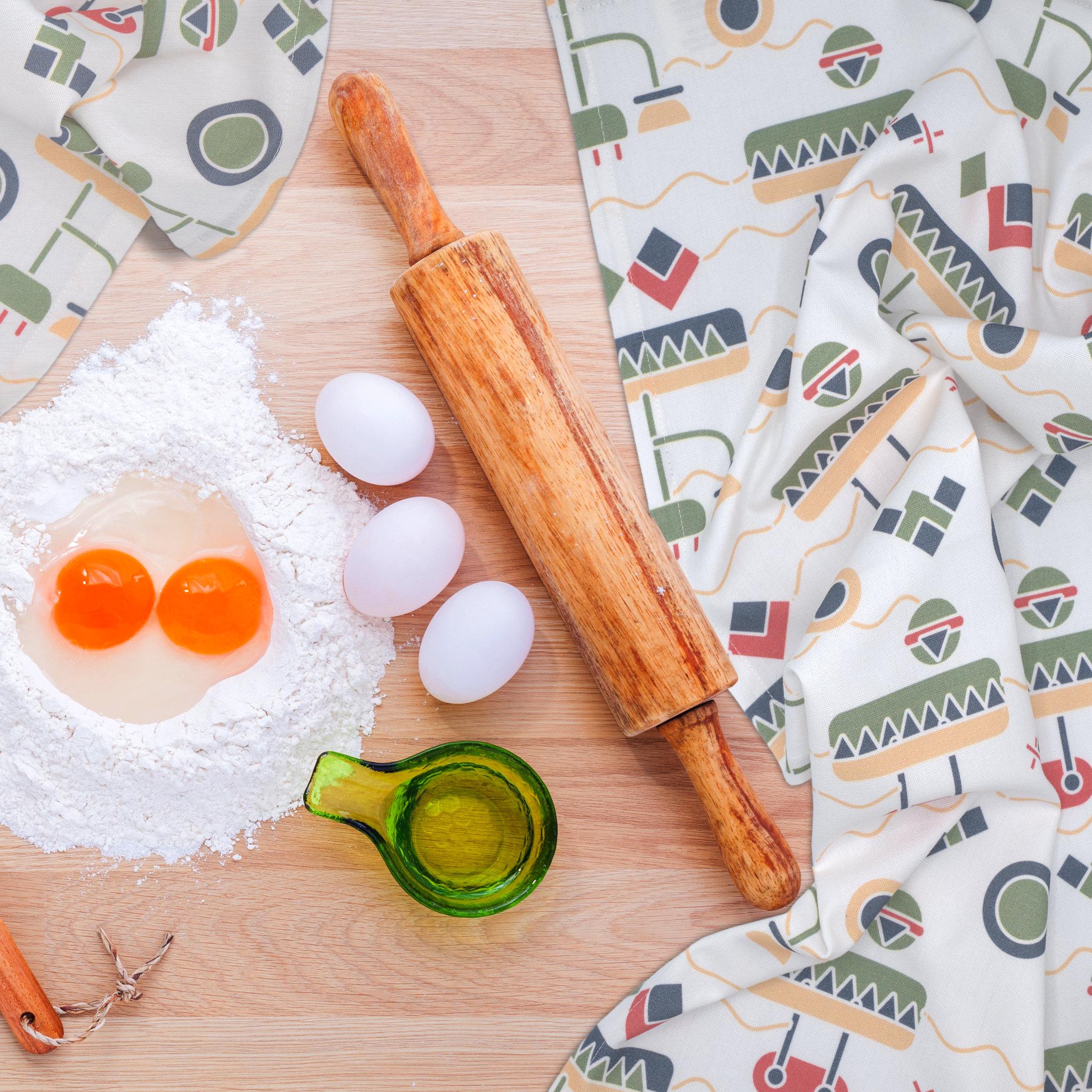 colorful cotton percale tea towels of thingies design on kitchen table with eggs and rolling pin
