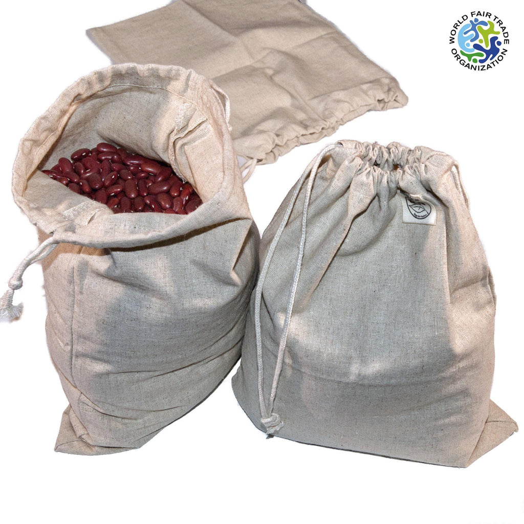 three fair trade hemp cotton produce bags one with close mouth and one with dry grains from Hem And Tassel  on a white background