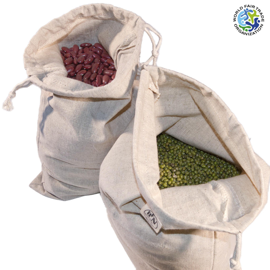 Two hemp cotton drawstring bags from Hem And Tassel  filled with beans and peas, with a visible World Fair Trade Organization logo.