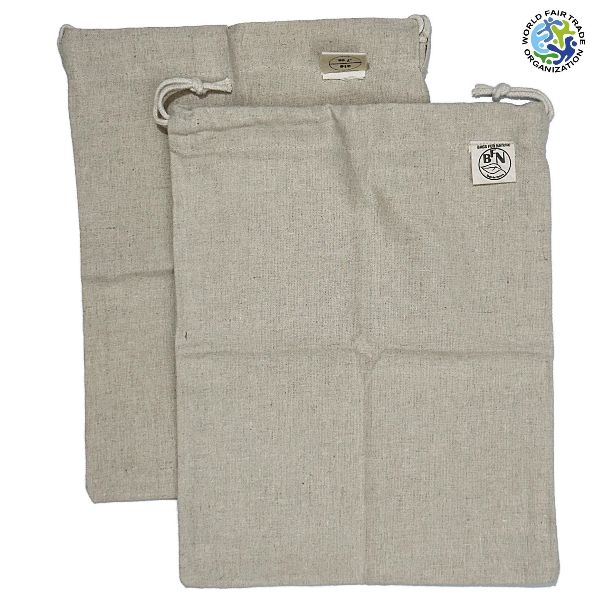 two fair trade hemp cotton produce bags with draw strings from Hem And Tassel  lying flat on a white background
