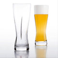 one empty slash beer glass and one full, made in Japan, from Hem And Tassel on a white background