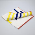 yellow piano cotton slub dinner napkin with red stitching from Hem And Tassel, on a light gray background