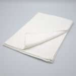 Jekyll and Hyde design tea towel in white folded from hem and tassel