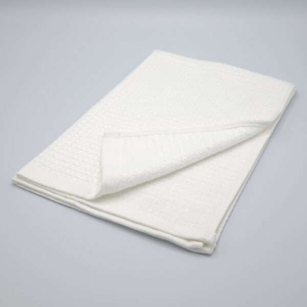 Jekyll and Hyde design tea towel in white folded from hem and tassel