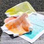 100% Cotton Towels, Colorful Distressed Print, rustic Tie Dye Look, three on picnic table