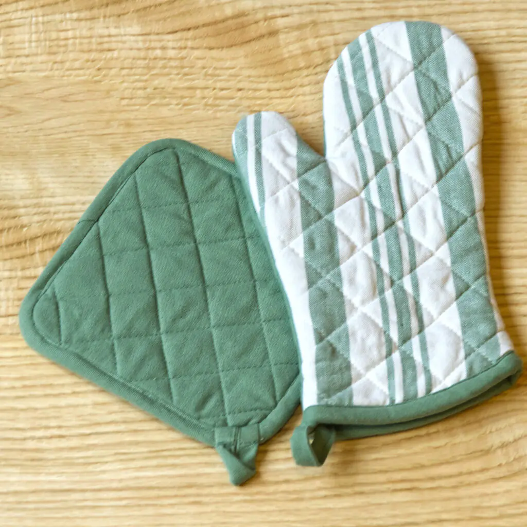 Quilted Decade classic oven mitt and pot holder shown in blue color