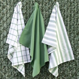 Three large 100% cotton kitchen towels in flat weave shown hanging, of decade classic style, in solid green, checks and stripes