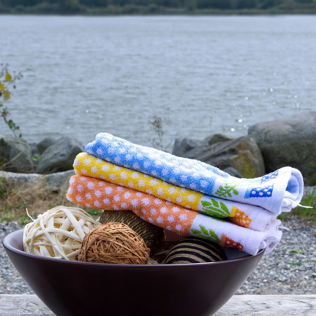 set of 3 deep pile terry towels, polka pot design, on BBQ table outdoors